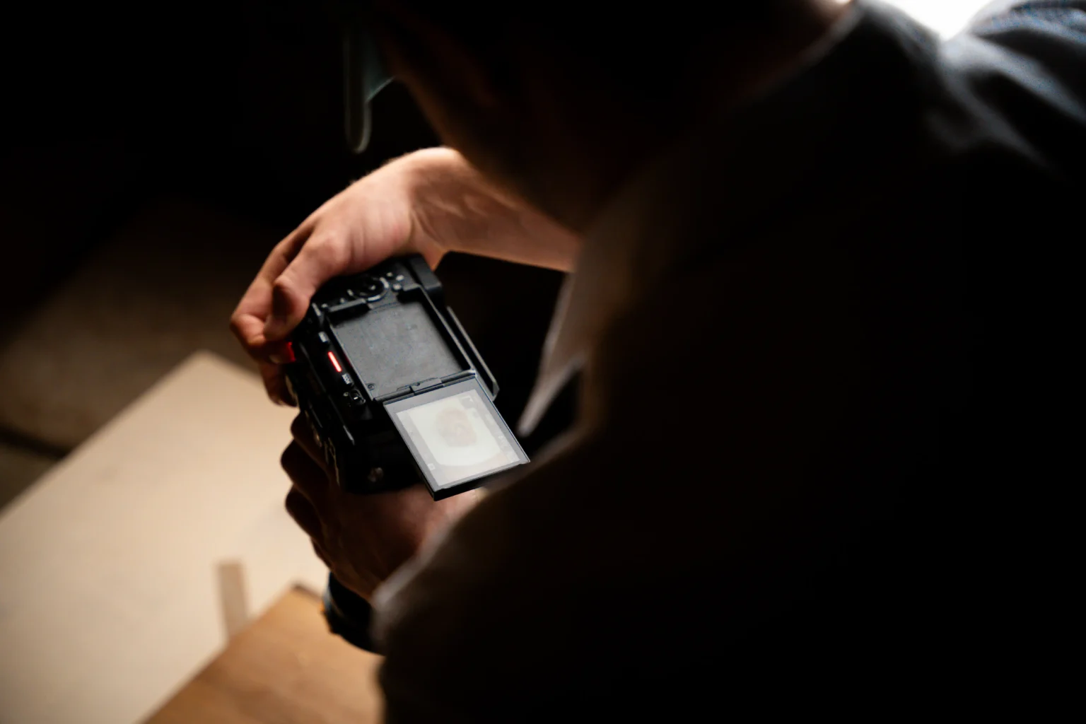Videograf überprüft Aufnahmen auf Kameradisplay während Food Shooting im Studio